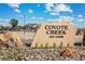 Welcoming entrance sign for Coyote Creek Golf Course, set amidst landscaped rocks and greenery at 2154 Alyssa St, Fort Lupton, CO 80621