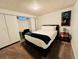 This bedroom features a large bed, a desk, and a closet for storage at 2543 Westchester Dr, Denver, CO 80221