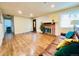 Bright living room with hardwood flooring, fireplace, and large window at 2543 Westchester Dr, Denver, CO 80221