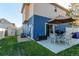 Cozy backyard patio with seating, umbrella, and well-maintained lawn, perfect for outdoor entertaining at 19149 E 55Th Ave, Denver, CO 80249