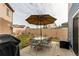 Cozy backyard with patio furniture, including a table, chairs, and large umbrella for shade at 19149 E 55Th Ave, Denver, CO 80249