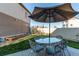 Landscaped backyard with a seating area with a table and umbrella on a well-maintained lawn at 19149 E 55Th Ave, Denver, CO 80249