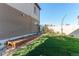 Backyard with a wooden garden box, lush green grass, and a privacy fence at 19149 E 55Th Ave, Denver, CO 80249