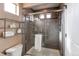 Updated bathroom featuring a tiled shower with glass doors and modern fixtures at 19149 E 55Th Ave, Denver, CO 80249