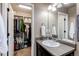 Bathroom vanity with sink, mirror, and an open closet for extra storage at 19149 E 55Th Ave, Denver, CO 80249