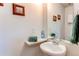 Cozy half bathroom features a pedestal sink, framed mirror, and fresh decor for a convenient space at 19149 E 55Th Ave, Denver, CO 80249