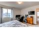 Bedroom featuring a dedicated desk/office space and large windows for natural light at 19149 E 55Th Ave, Denver, CO 80249