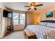 Relaxing bedroom with natural light, mounted TV, and comfortable bed for a restful retreat at 19149 E 55Th Ave, Denver, CO 80249