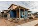 Modern two-story home with blue siding, a covered entryway, and a landscaped front yard at 19149 E 55Th Ave, Denver, CO 80249