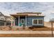 Two-story home with blue siding, a covered porch, and a well-maintained front yard at 19149 E 55Th Ave, Denver, CO 80249