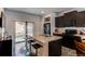 Spacious kitchen features a large island, black appliances, and sliding glass doors to the backyard patio at 19149 E 55Th Ave, Denver, CO 80249