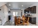 Modern kitchen with dark cabinets, granite countertops, and an island with seating at 19149 E 55Th Ave, Denver, CO 80249