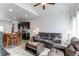 Open living room showcases a comfortable leather sofa, wooden dining table, and dark cabinetry at 19149 E 55Th Ave, Denver, CO 80249