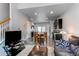 Open concept living room and kitchen with recessed lighting and dark cabinetry at 19149 E 55Th Ave, Denver, CO 80249