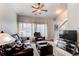 Cozy living room featuring vaulted ceiling, a leather sofa, and a ceiling fan at 19149 E 55Th Ave, Denver, CO 80249