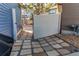 View of a side yard featuring stone pavers and a small gravel area leading to a fenced pathway at 19149 E 55Th Ave, Denver, CO 80249