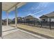 A view of the fenced backyard with blue skies at 8946 S Rome Ct, Aurora, CO 80016