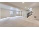 Large unfinished basement with stairs and natural light at 8946 S Rome Ct, Aurora, CO 80016