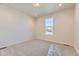 Neutral bedroom with carpet and a large window overlooking the neighborhood at 8946 S Rome Ct, Aurora, CO 80016