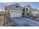 Gray two-story home with a two-car garage, covered entryway, and contemporary design at 8946 S Rome Ct, Aurora, CO 80016