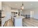 Well-lit kitchen featuring a center island, white cabinets, and stainless steel appliances at 8946 S Rome Ct, Aurora, CO 80016