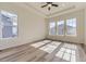 Bright main bedroom with ceiling fan, tray ceiling, and large windows at 8946 S Rome Ct, Aurora, CO 80016