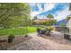 Expansive backyard with a stone patio, outdoor seating under an umbrella, and a hot tub for relaxation at 4814 Kingbird Dr, Frederick, CO 80504