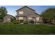 Spacious backyard with a patio, hot tub, and outdoor dining area, perfect for entertaining and enjoying outdoor living at 4814 Kingbird Dr, Frederick, CO 80504