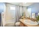 Traditional bathroom with a bathtub, white tile, and light wood vanity, offering a clean and simple design at 4814 Kingbird Dr, Frederick, CO 80504