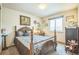 Cozy bedroom with vintage wood furniture, soft carpet, and a bright window overlooking the yard at 4814 Kingbird Dr, Frederick, CO 80504