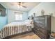 Well-lit bedroom featuring modern furniture, neutral carpet, and a large window providing natural light at 4814 Kingbird Dr, Frederick, CO 80504