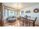 Dining room features a bay window with seating, chandelier and wood floors at 4814 Kingbird Dr, Frederick, CO 80504