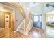 Welcoming entryway with high ceilings, wood floors, and staircase to the upper level at 4814 Kingbird Dr, Frederick, CO 80504