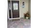 Inviting front entrance with a dark wood door, brick walkway, and decorative potted plants, showcasing curb appeal at 4814 Kingbird Dr, Frederick, CO 80504