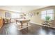 Spacious game room with a pool table, dark floors, and natural light from large windows at 4814 Kingbird Dr, Frederick, CO 80504