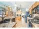 Well-equipped kitchen with stainless steel appliances and an open view to the dining area and stairs at 4814 Kingbird Dr, Frederick, CO 80504