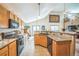 Bright kitchen features wooden cabinets, tile backsplash, and gas range at 4814 Kingbird Dr, Frederick, CO 80504