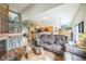 Cozy living room with a fireplace, comfortable seating, and an open layout to the kitchen at 4814 Kingbird Dr, Frederick, CO 80504