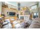 Bright living room boasts a fireplace, comfortable seating, and an open staircase to the upper level at 4814 Kingbird Dr, Frederick, CO 80504