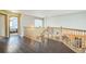 Spacious upstairs hallway with hardwood flooring and view to the kitchen at 4814 Kingbird Dr, Frederick, CO 80504