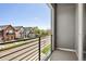 Balcony view overlooking a quiet street with well-maintained homes and lush green trees at 4395 Zuni St, Denver, CO 80211