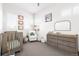 Charming Bedroom with a crib, changing table, and soft decor, creating a cozy and nurturing environment at 4395 Zuni St, Denver, CO 80211