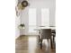 Dining area with large windows, stylish chairs, a marble table, and decorative wall hangings at 4395 Zuni St, Denver, CO 80211