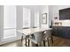 Elegant dining area with marble table, modern chairs, and a bar area at 4395 Zuni St, Denver, CO 80211