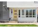 Charming home exterior with a modern yellow front door at 4395 Zuni St, Denver, CO 80211