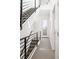 Bright hallway with modern staircase, natural light, and neutral carpeting, creating a welcoming transition space at 4395 Zuni St, Denver, CO 80211