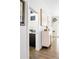 Hallway with a view of a powder room featuring geometric tiles and modern fixtures at 4395 Zuni St, Denver, CO 80211