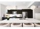Bright kitchen featuring a large island with seating, modern appliances, and elegant sphere pendant lighting at 4395 Zuni St, Denver, CO 80211