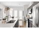 Contemporary kitchen featuring stainless steel appliances, island seating, and unique decorative wall art at 4395 Zuni St, Denver, CO 80211