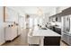 Open concept kitchen with a spacious island, stainless steel appliances, and modern lighting fixtures at 4395 Zuni St, Denver, CO 80211